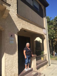 Herlinda Anguiano in front of her home off of Figueroa. Developers plan to bulldoze her home of 40 years.